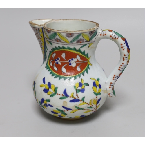 390 - Turkish Kutahya pottery jug hand painted with stylised flowers, 12.5cm high