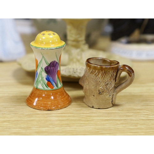 414 - A Royal Doulton mug, two figures and a jar, a Clarice Cliff pepper and four other items (9), tallest... 