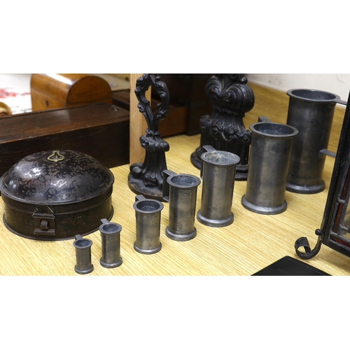 424 - A graduated set of seven French pewter measures, a toleware spice box and two cast iron door stops (... 