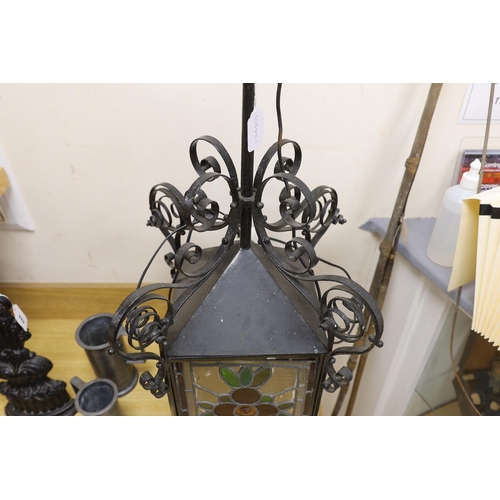 425 - A late 19th/early 20th century Arts and Crafts style wrought iron and stained glass panelled hanging... 