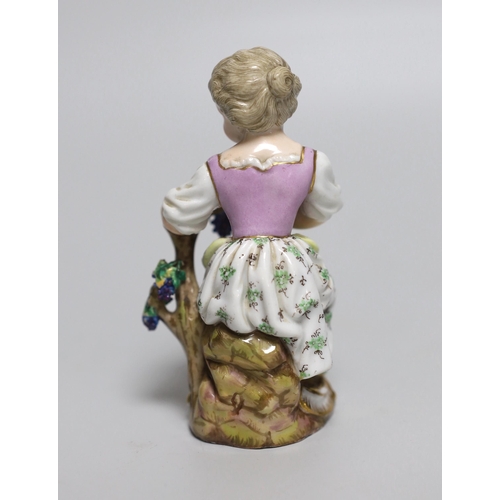 432 - An early 19th century Meissen figure of a girl seated on a tree stump holding a bunch of grapes, pai... 