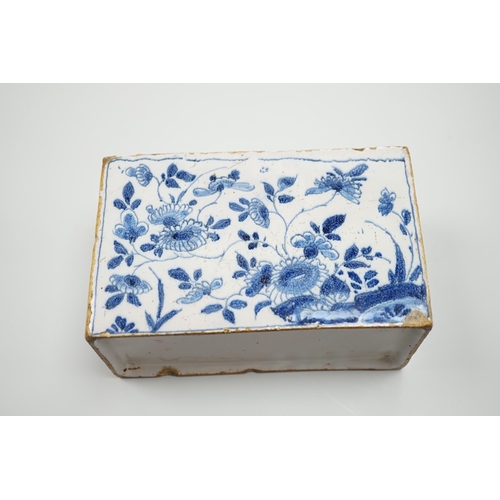 437 - A mid 18th century English delftware flower brick, probably Lambeth, painted in underglaze blue with... 