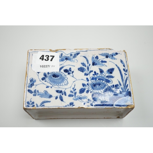 437 - A mid 18th century English delftware flower brick, probably Lambeth, painted in underglaze blue with... 