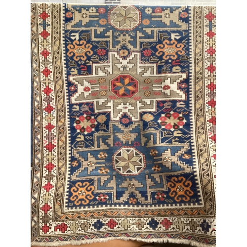 5 - An antique Shirvan Lesghi design blue ground triple medallion rug, 148cm x 106cm