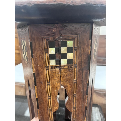 56 - A Moorish mother of pearl inlaid hexagonal occasional table, width 32cm, height 46cm