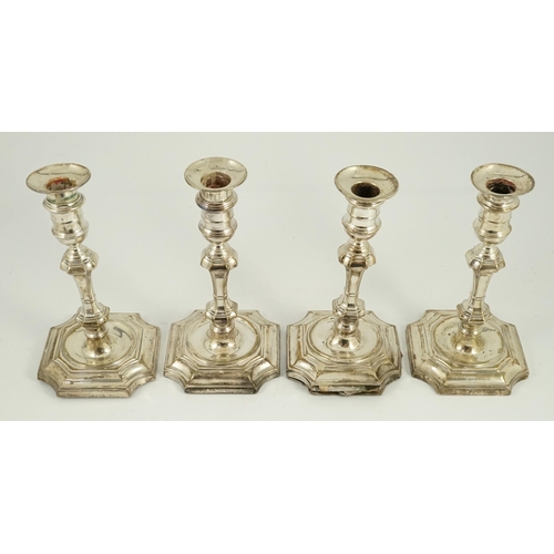 803 - A matched set of four Victorian and later silver candlesticks, by Hawksworth, Eyre & Co Ltd, with wa... 