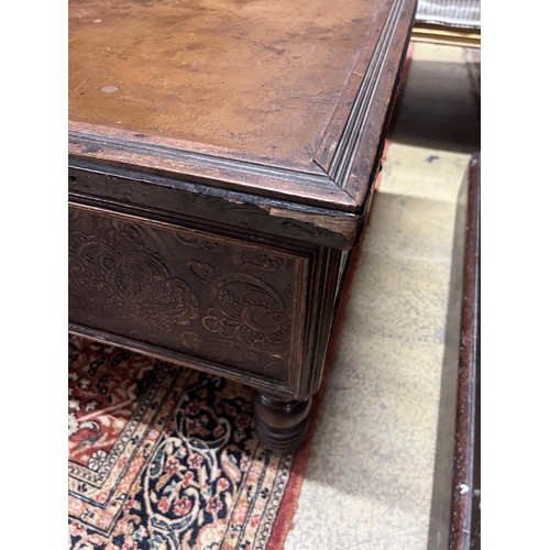 87 - A rectangular embossed leather covered mahogany coffee table on turned feet, incorporates old timber... 