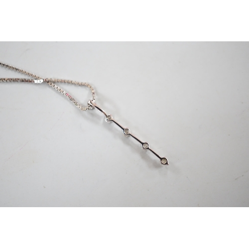 875 - A modern 750 white metal and five stone diamond chip set line pendant, 25mm, on an 18kt white metal ... 