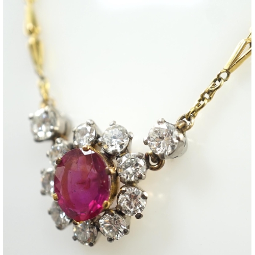 887 - A modern 9ct gold, single stone oval cut ruby and eleven stone round cut diamond cluster set pendant... 