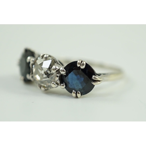 897 - A white gold, sapphire and diamond set three stone ring, central stone approximately 1.4ct the diamo... 