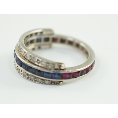 900 - A mid 20th century white gold, diamond, ruby and sapphire set swivelling triple band eternity ring, ... 