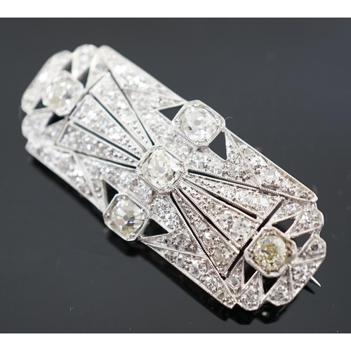 901 - An Art Deco pierced platinum and millegrain set diamond cluster shaped rectangular brooch, set with ... 