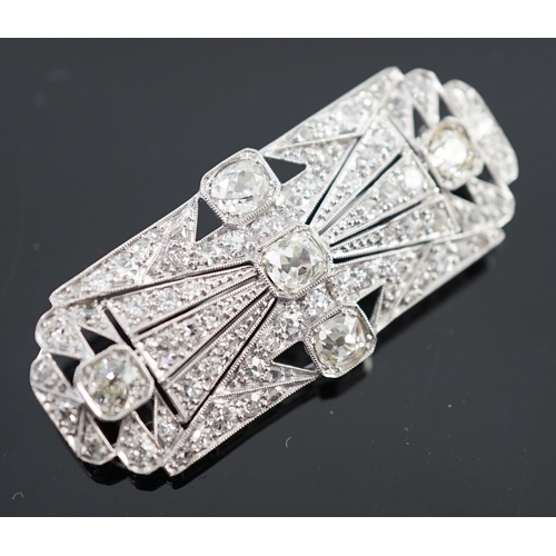 901 - An Art Deco pierced platinum and millegrain set diamond cluster shaped rectangular brooch, set with ... 