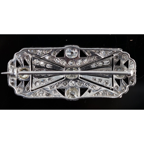 901 - An Art Deco pierced platinum and millegrain set diamond cluster shaped rectangular brooch, set with ... 