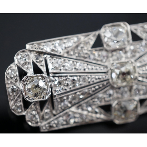 901 - An Art Deco pierced platinum and millegrain set diamond cluster shaped rectangular brooch, set with ... 