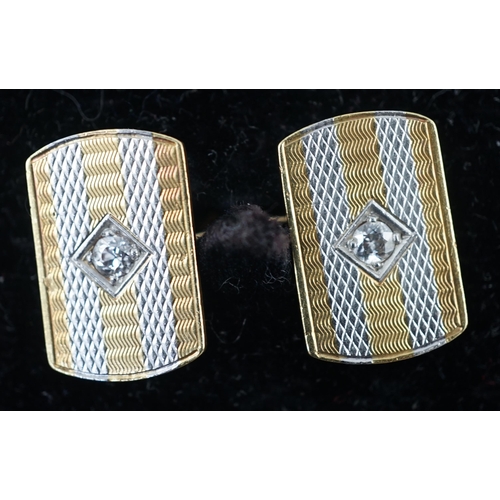 902 - A pair of mid 20th century two colour 18ct gold and single stone diamond set cufflinks, of shaped re... 