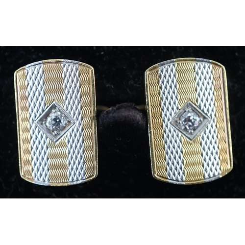 902 - A pair of mid 20th century two colour 18ct gold and single stone diamond set cufflinks, of shaped re... 