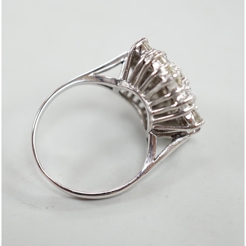 910 - An 18ct white metal and diamond set hexagonal cluster ring, size L, gross weight 6.3 grams.