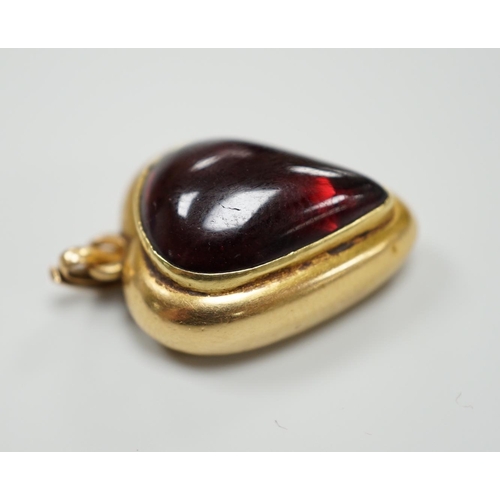 921 - A late Victorian yellow metal (stamped 18) and cabochon garnet set heart shaped pendant, with glazed... 