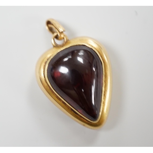 921 - A late Victorian yellow metal (stamped 18) and cabochon garnet set heart shaped pendant, with glazed... 