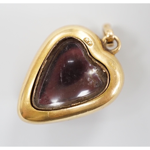 921 - A late Victorian yellow metal (stamped 18) and cabochon garnet set heart shaped pendant, with glazed... 