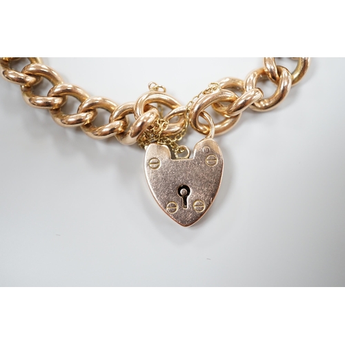 927 - A 9ct gold curb link bracelet, with heart shaped padlock clasp, 18cm, 32.8 grams.