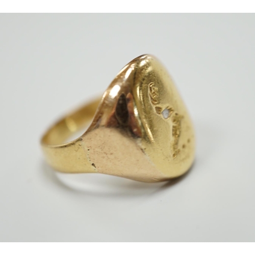 930 - A yellow metal signet ring, carved with a crest, size K, 5.2 grams.