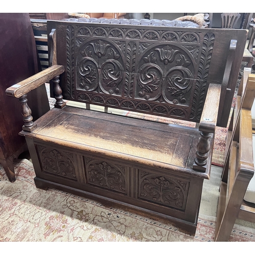 94 - A 1920s carved oak monk's bench, width 122cm, depth 51cm, height 78cm