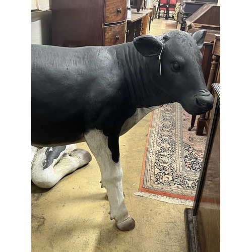 3 - A life size composition Friesian calf garden ornament, length 118cm, height 96cm