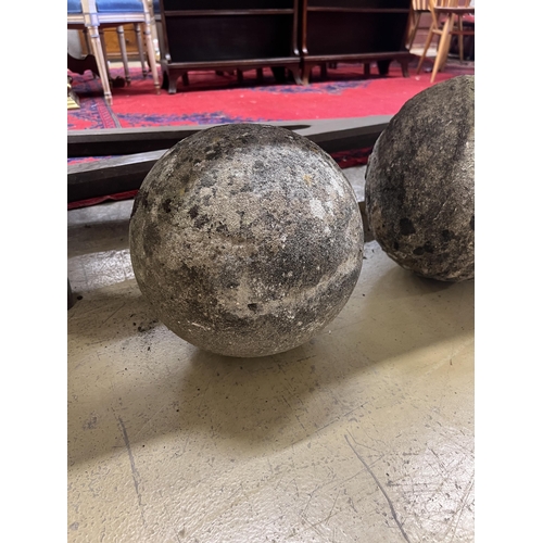 1025 - A trio of graduated reconstituted weathered stone ball finials, largest height 37cm