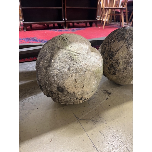 1025 - A trio of graduated reconstituted weathered stone ball finials, largest height 37cm