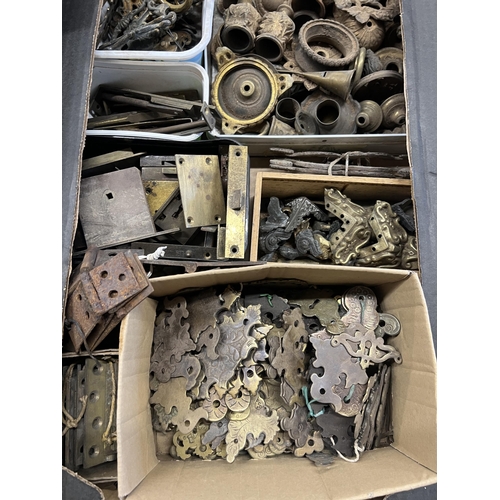 1026 - A quantity of assorted brass furniture mounts, escutcheons, locks, hinges, etc.