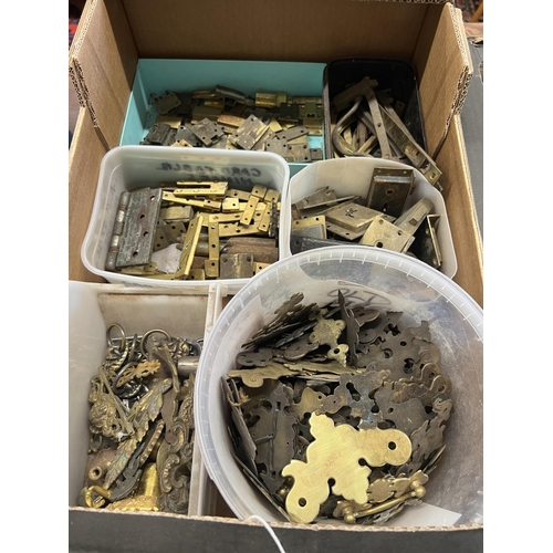 1026 - A quantity of assorted brass furniture mounts, escutcheons, locks, hinges, etc.