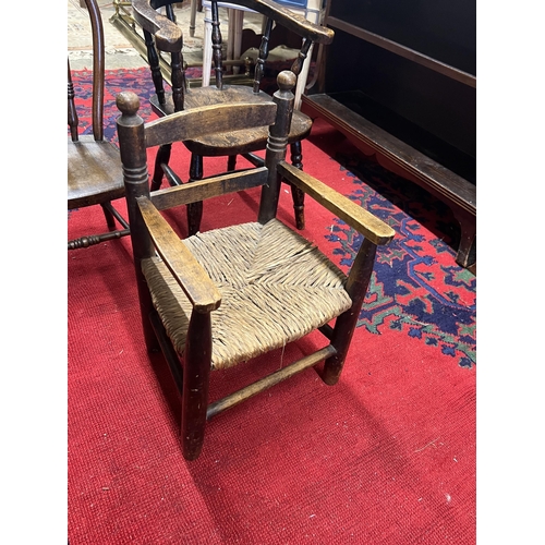 1033 - A child's Victorian elm and beech bow chair, a single chair and a rush seat chair