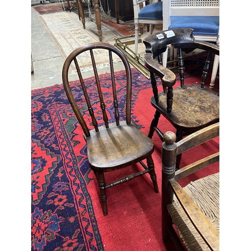 1033 - A child's Victorian elm and beech bow chair, a single chair and a rush seat chair