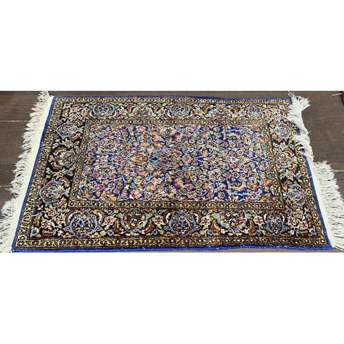 1038 - A North West Persian part silk blue ground rug, 89cm x 58cm