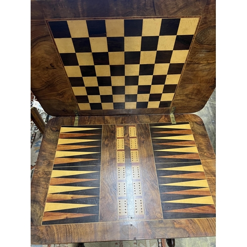 1043 - A Victorian figured walnut rectangular sewing / games table, width 58cm, depth 41cm, height 69cm... 