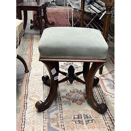 1052 - A Victorian rosewood dressing stool on scrolled supports, width 46cm, height 48cm