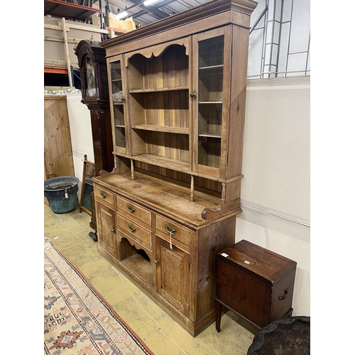 1075 - An early 20th century bleached oak dresser, width 165cm, depth 48cm, height 223cm