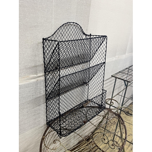 1080 - A painted wrought iron three tier pot stand, width 100cm, together with an oval wrought iron garden ... 