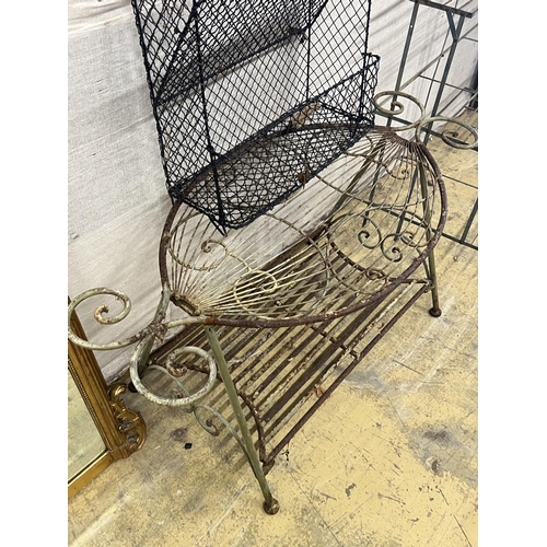 1080 - A painted wrought iron three tier pot stand, width 100cm, together with an oval wrought iron garden ... 