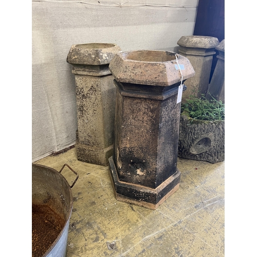 1084 - A pair of hexagonal terracotta chimney pots, larger height 71cm