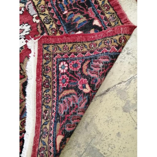 1091 - A Tabriz red ground carpet, 345cm x 241cm