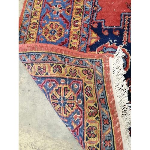 1092 - A Turkish red ground carpet, 337cm x 249cm