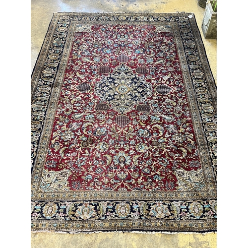 1105 - A Tabriz part silk burgundy ground rug, 218 x 150cm