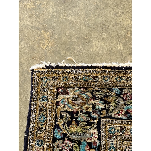 1105 - A Tabriz part silk burgundy ground rug, 218 x 150cm