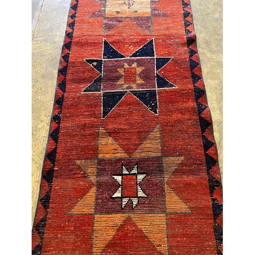 1125 - A Turkish red ground geometric runner, 298 x 87cm