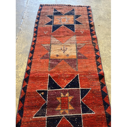 1125 - A Turkish red ground geometric runner, 298 x 87cm