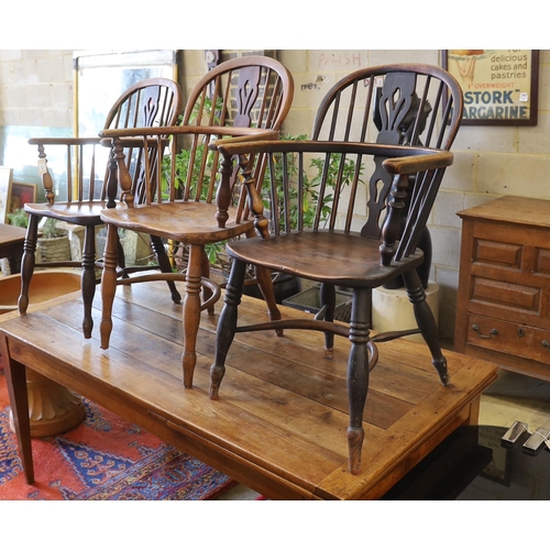 1129 - Three 19th century Nottingham area Windsor ash and elm elbow chairs with crinoline stretchers, large... 