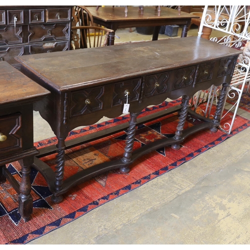 1137 - An 18th century style oak three drawer low dresser on spiral turned legs, incorporates old timber, w... 